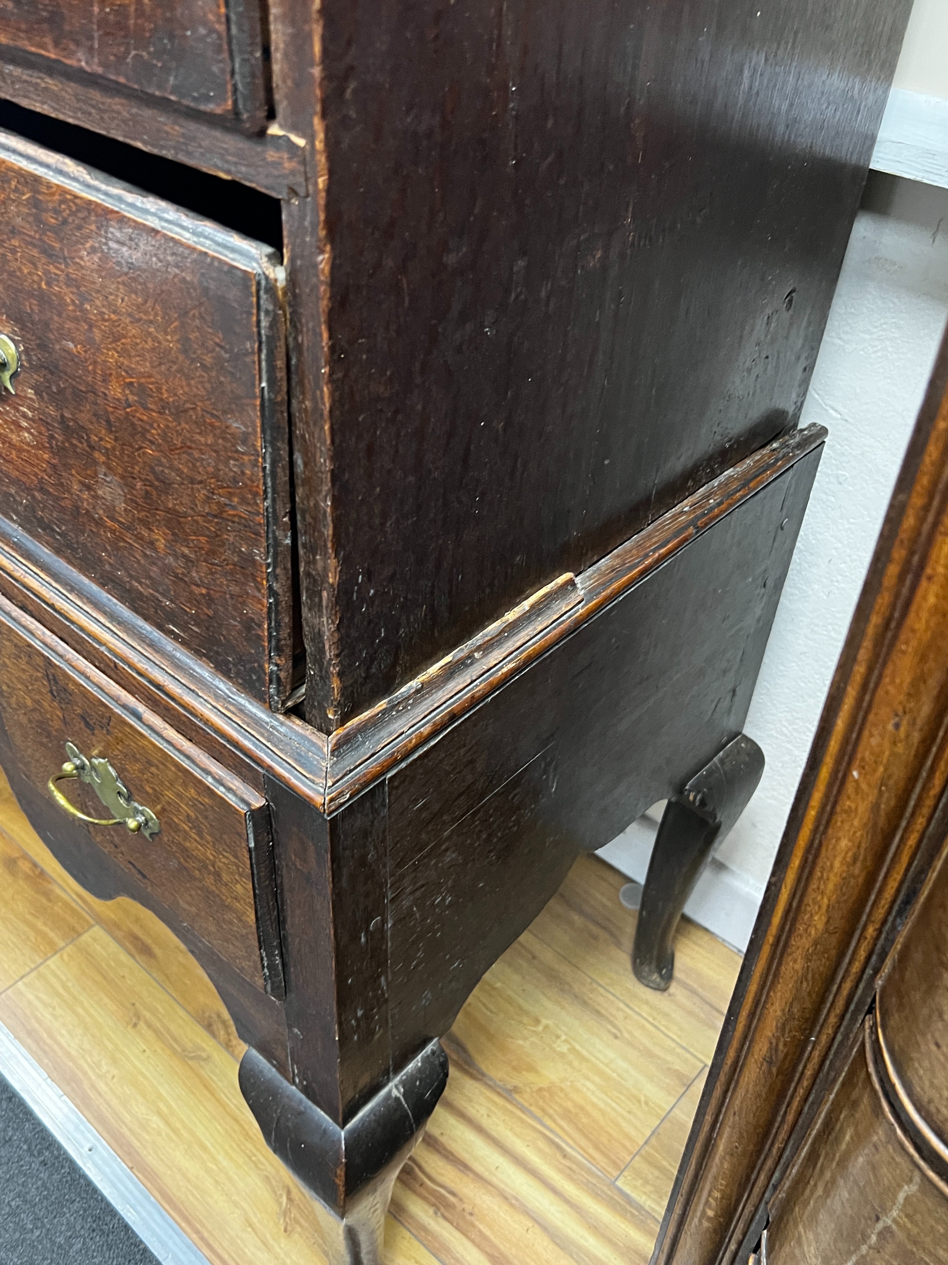 An 18th century oak chest on stand, width 99cm, depth 48cm, height 154cm